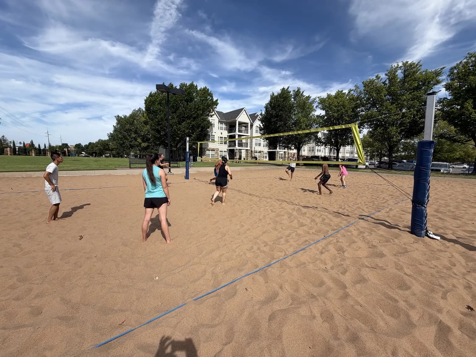 Players on both sides of the net transition into position during a wide rally