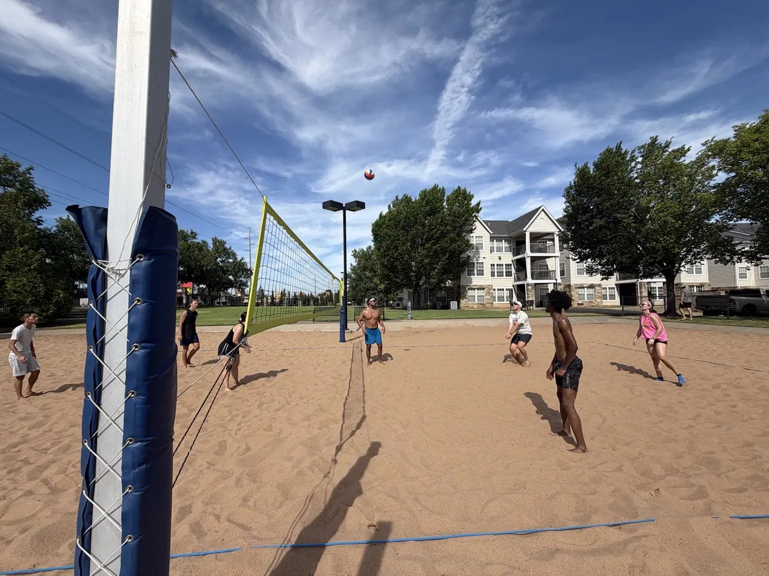 A high ball crosses a wide August 15 court as both teams prepare for the next touch