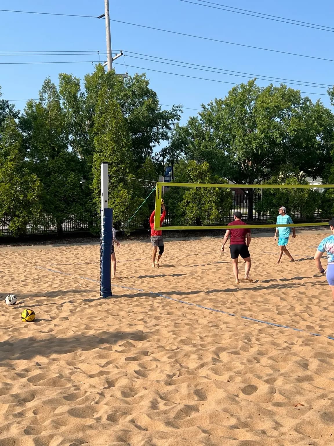 A Sandline player plays the ball at the net during the August 8 pickup