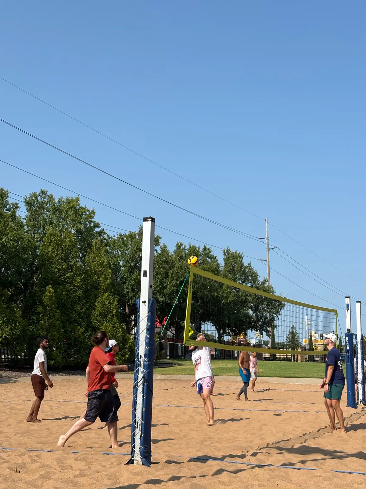 Players on both sides of the net move through an August 8 Sandline rally