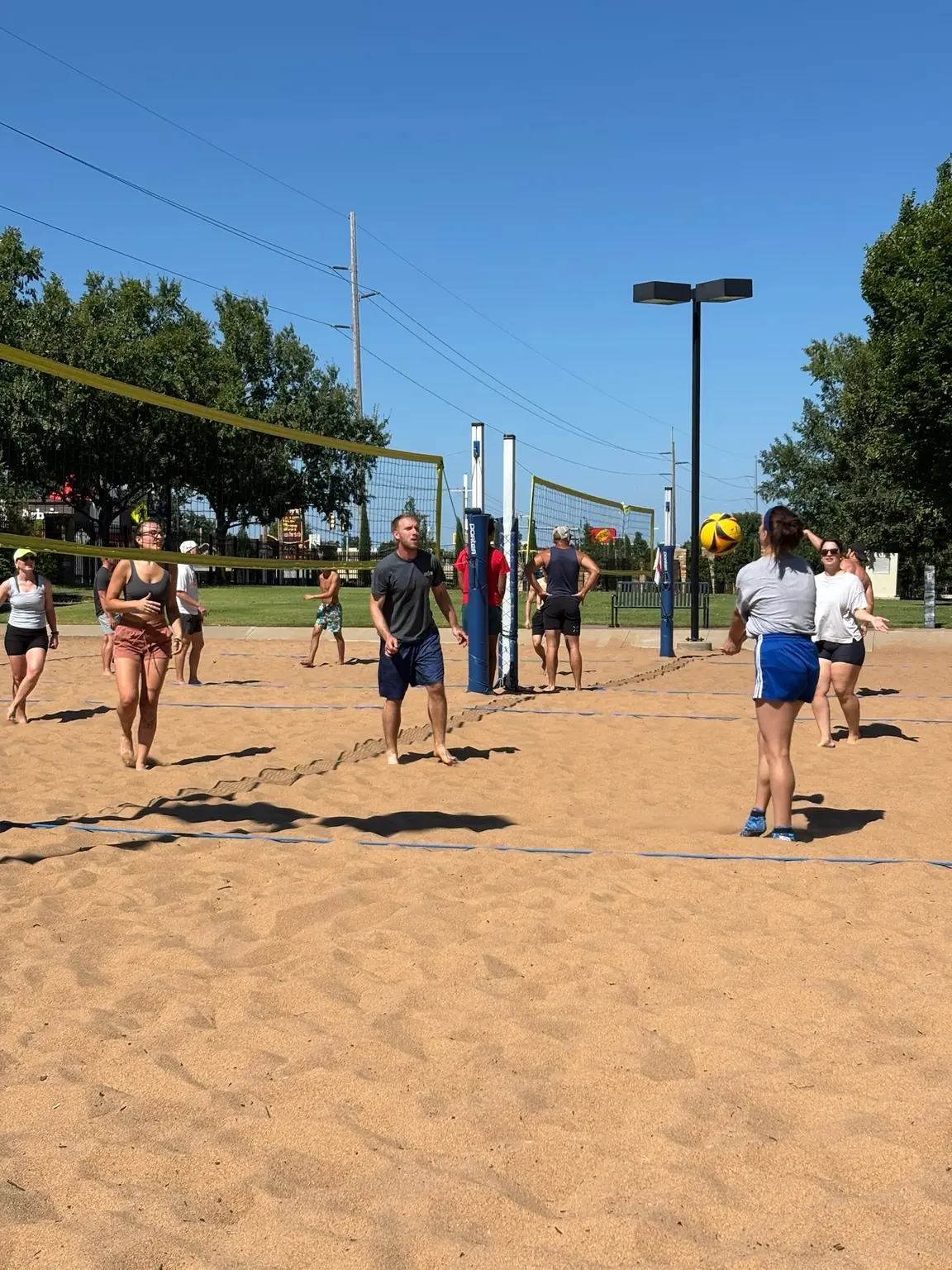 A player in the back row sending the ball forward during pickup volleyball