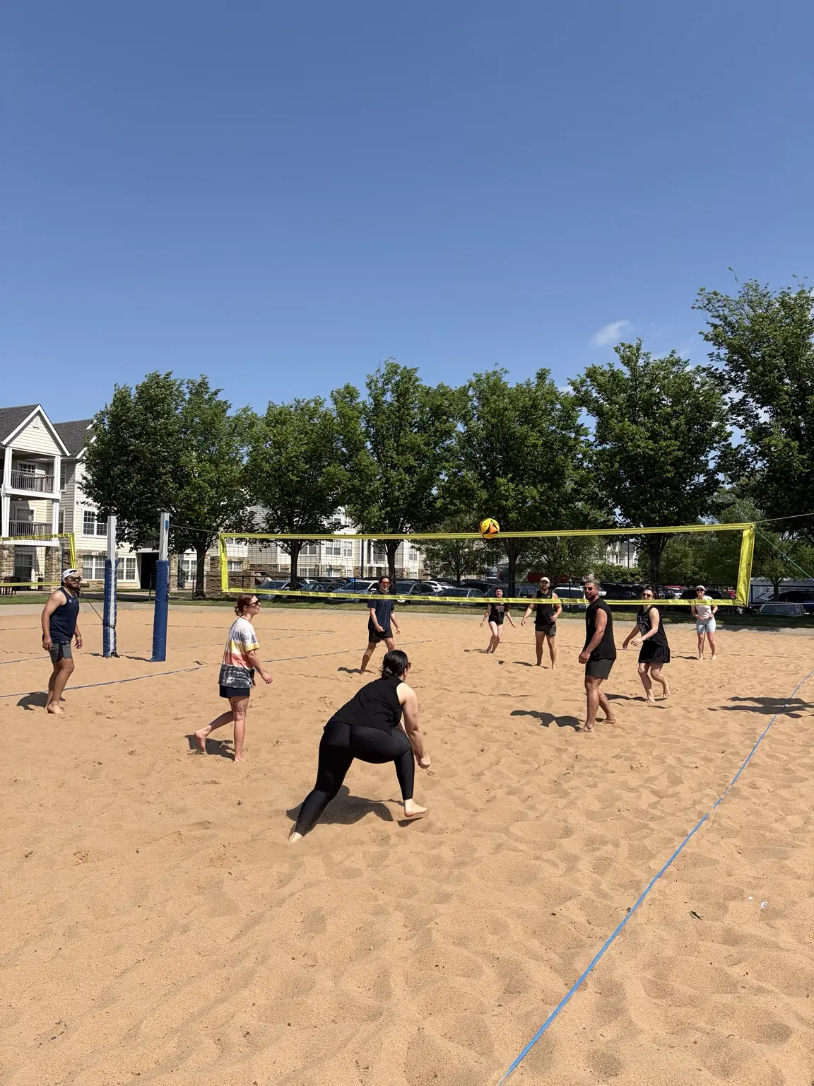 A player lowering into position to dig a ball during pickup