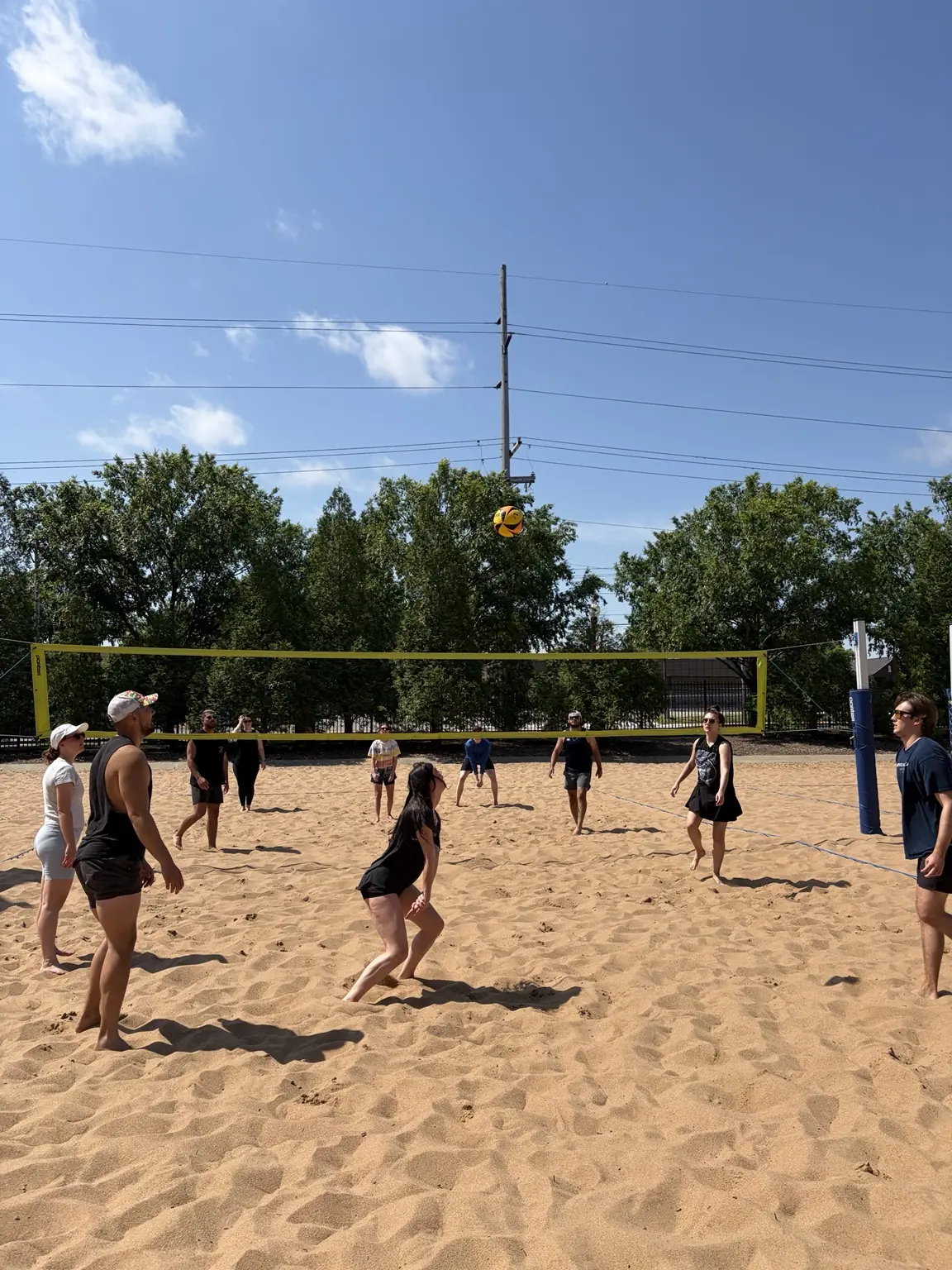 Players transitioning from defense to offense during a sand volleyball rally