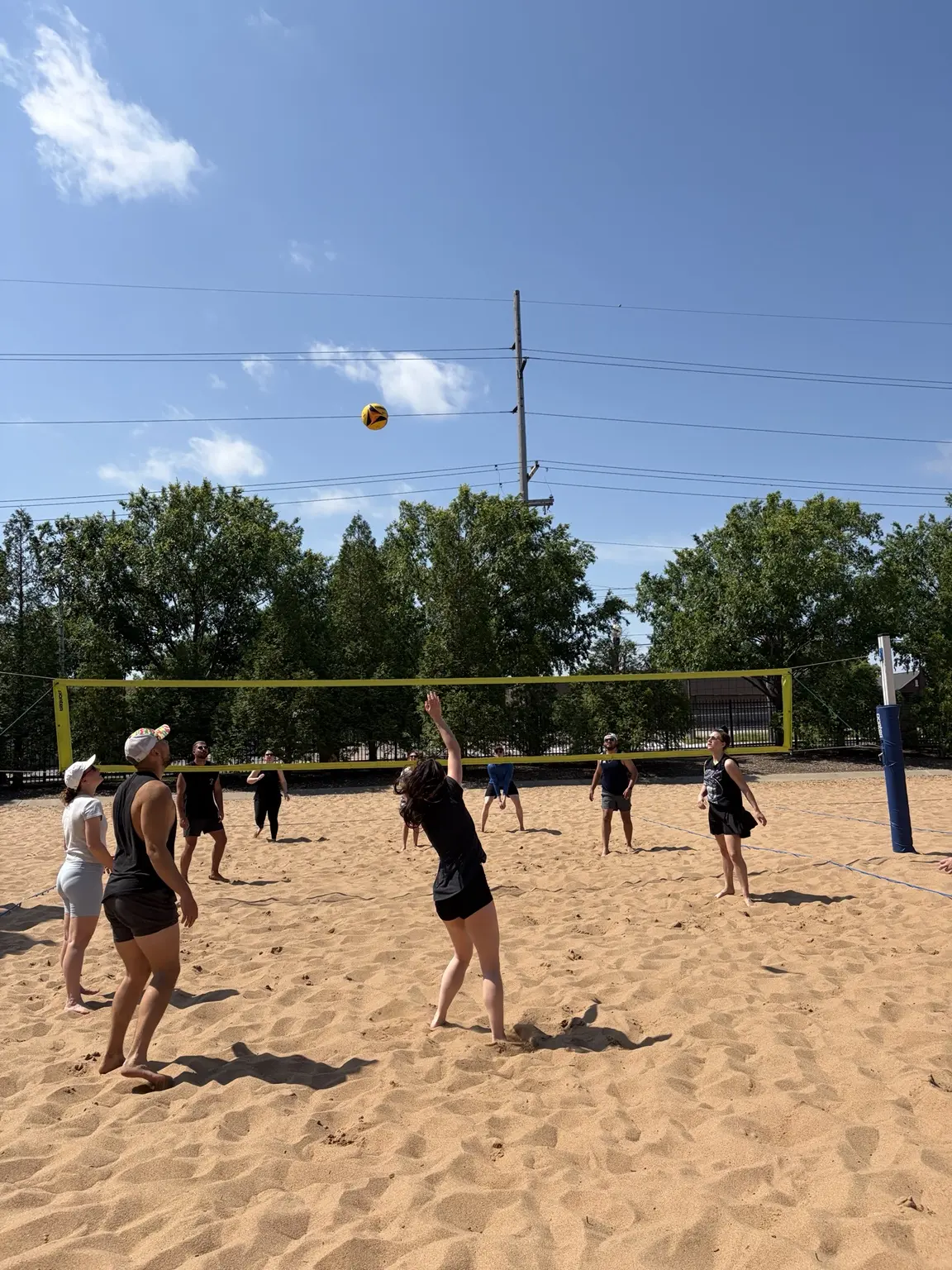 Sandline players reading a high ball during a pickup game